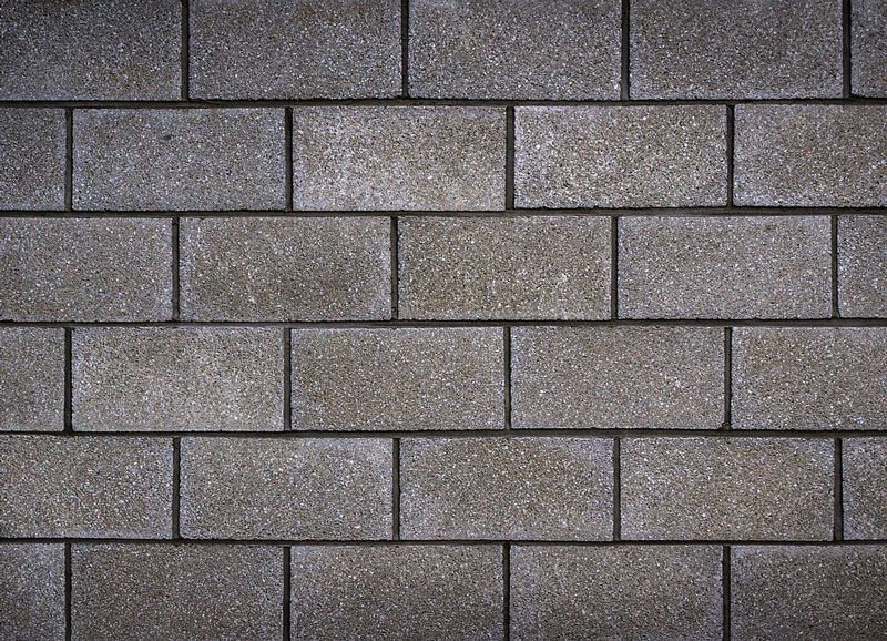 A close up of a brick wall made of concrete blocks.