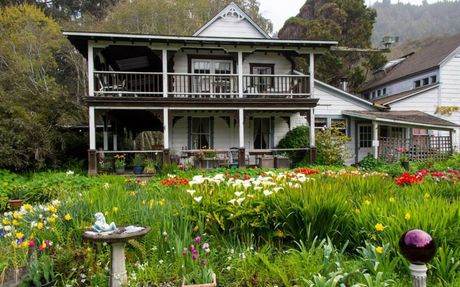 Gardens and the original farmhouse at the Howard Creek Ranch Inn.