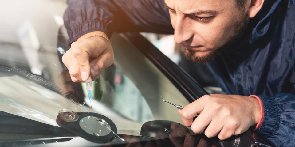 Person Fixing Car Chip Screen