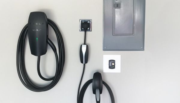 Mend Electric LLC - A tesla charging station is attached to a wall.