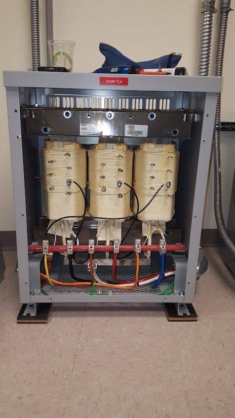 Mend Electric LLC - A transformer is sitting on the floor in a room.