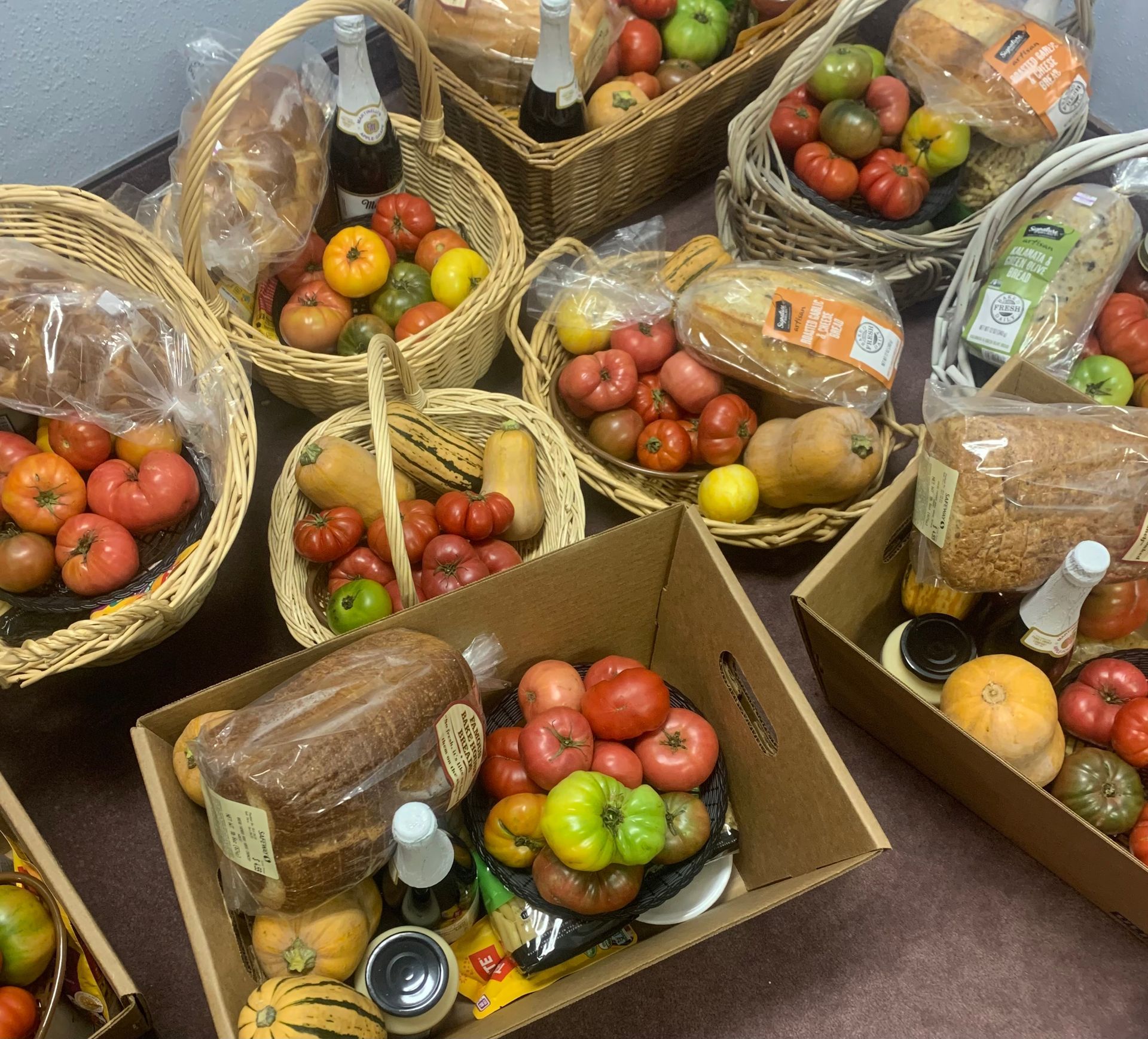 A bunch of baskets and boxes filled with fresh produce from the garden for the church food bank.
