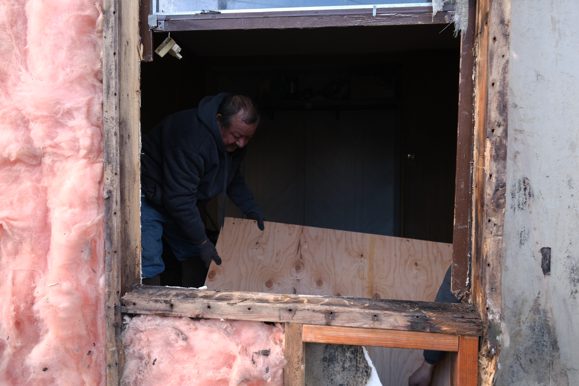 Volunteers working on a window