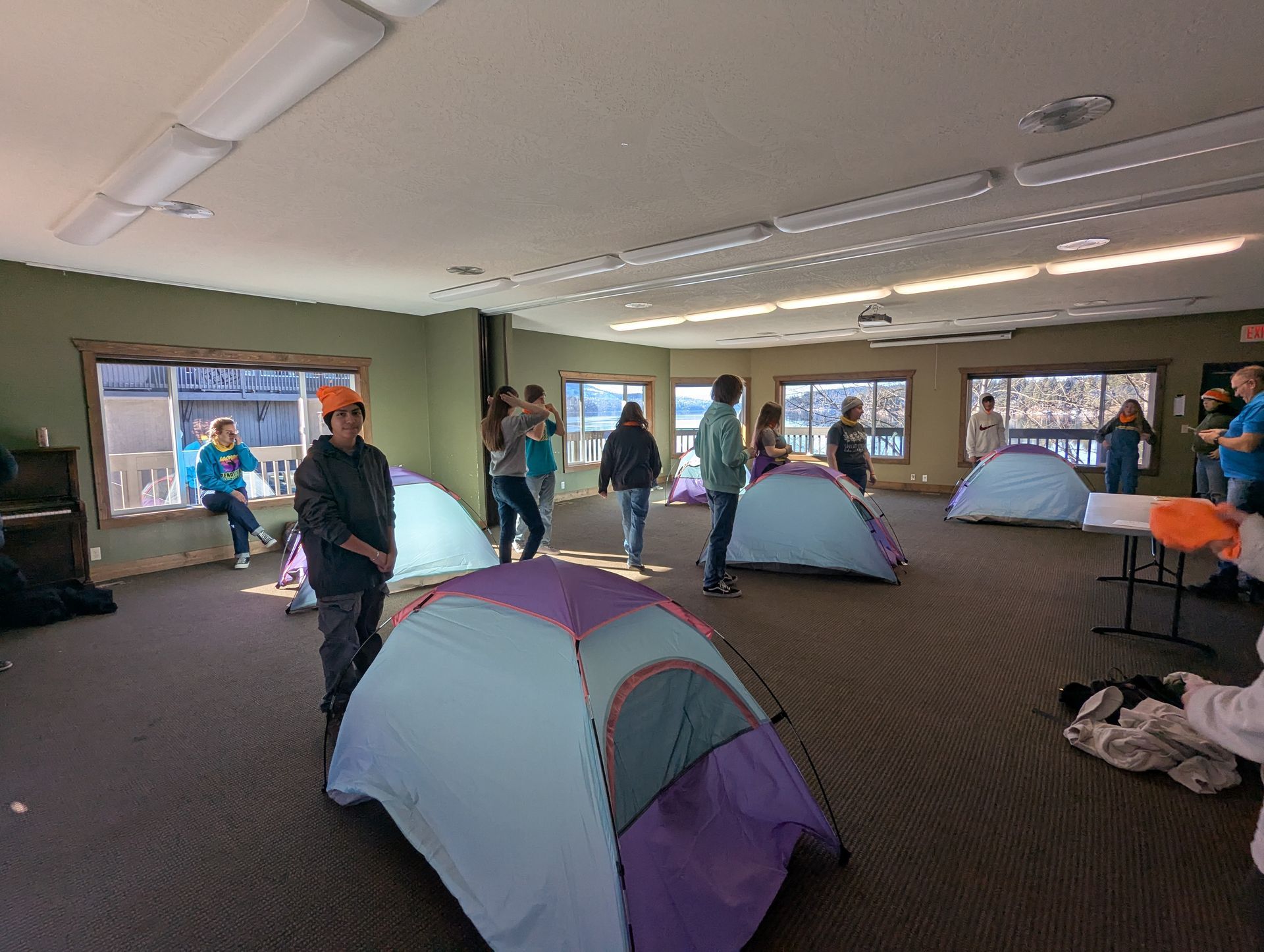 Pathfinders set up tents while blindfolded during a trust exercise.