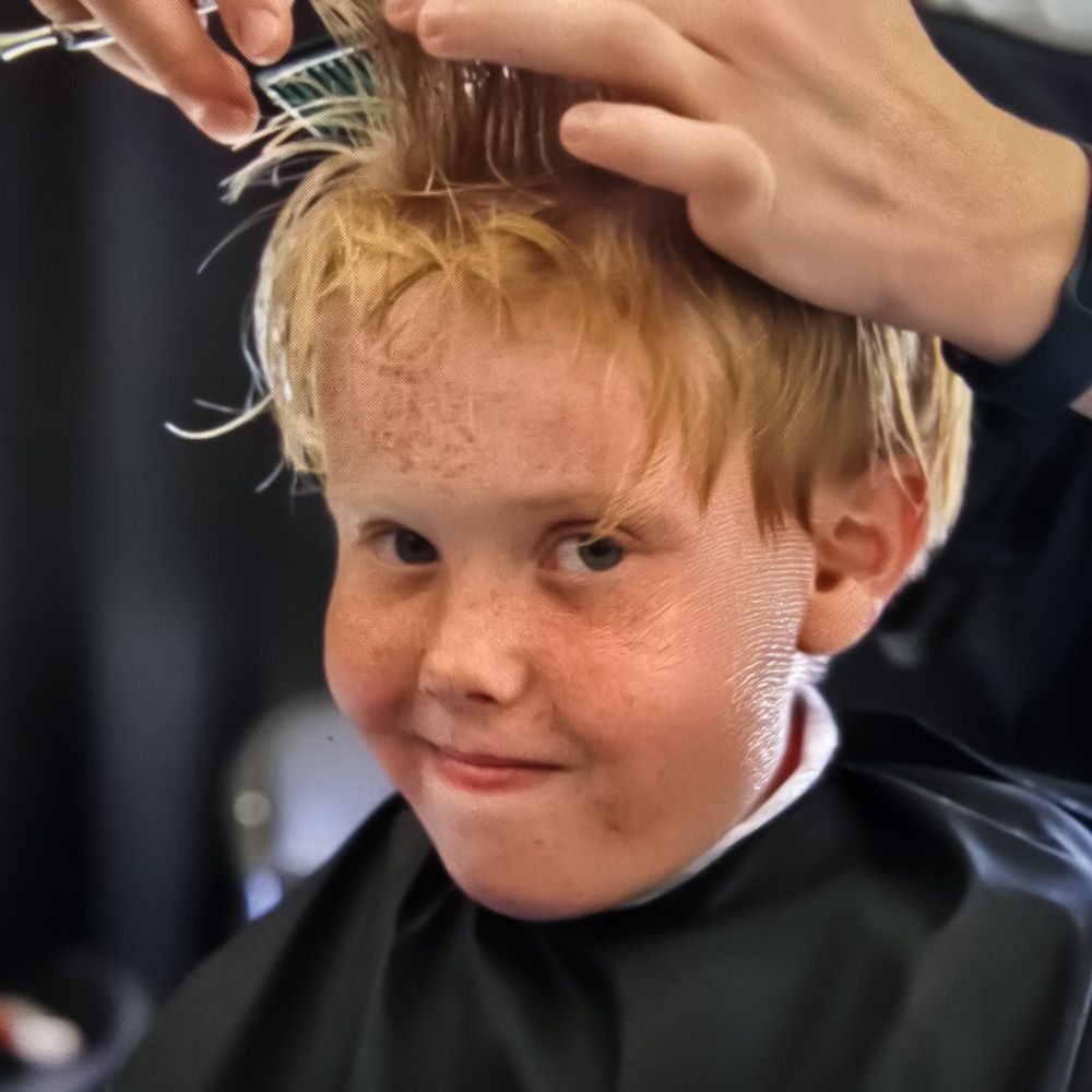 A boy getting a free haircut at the Northern Idaho State Fair