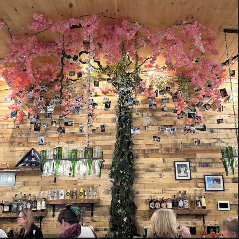A restaurant with a cherry blossom tree hanging from the ceiling