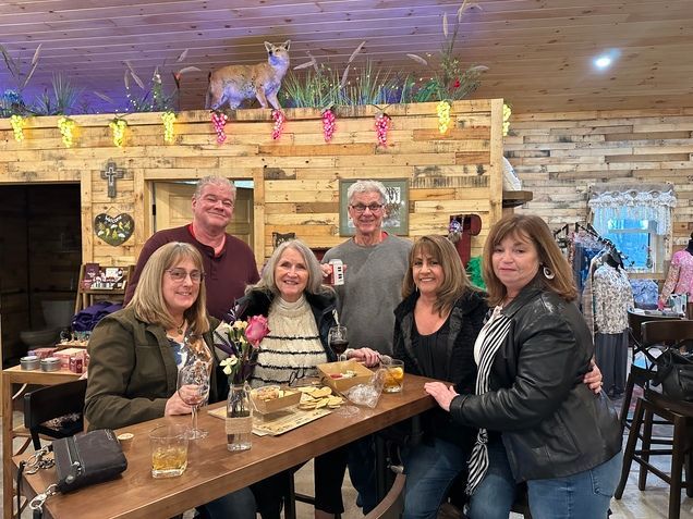 A group of people are sitting at a table in a restaurant.