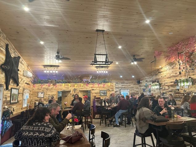 A group of people are sitting at tables in a restaurant.