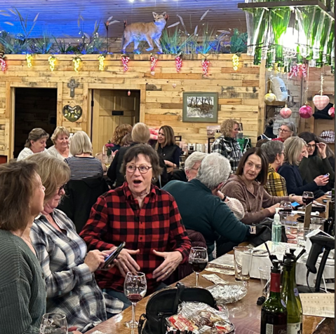 A group of people are sitting at tables in a restaurant.