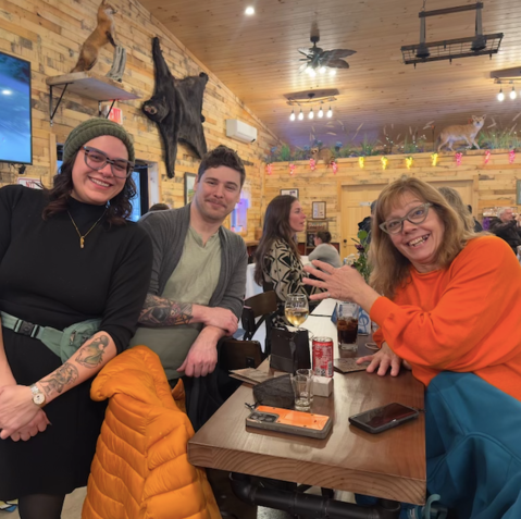 A group of people are sitting at a table in a restaurant