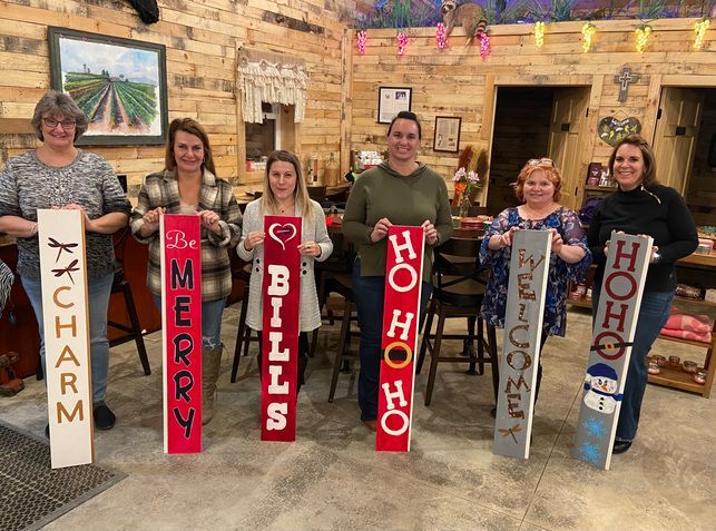 A group of people are standing next to each other holding signs.