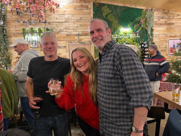 A group of people are posing for a picture in a restaurant.