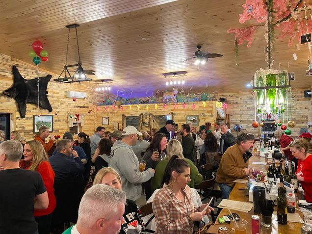 A large group of people are sitting at tables in a restaurant.