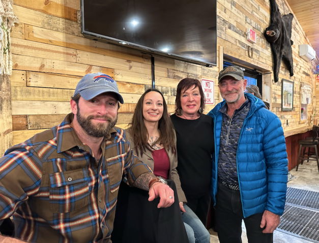 A group of people are posing for a picture in a restaurant.