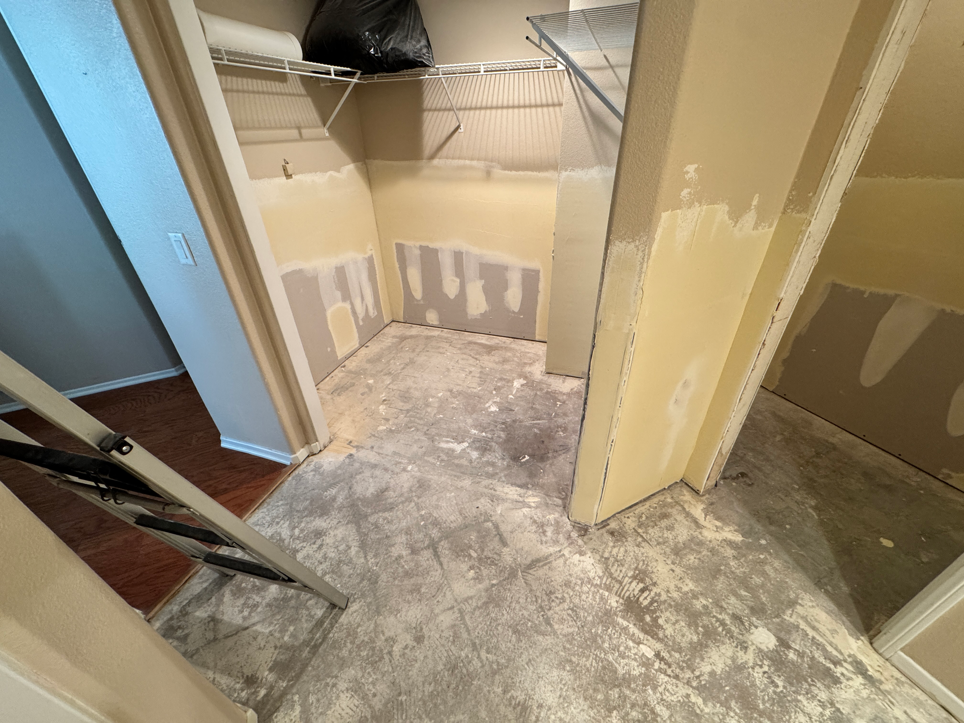 Before–after water damage repair: buckled hardwood and wet drywall vs. stabilized, replaced flooring and repainted wall.