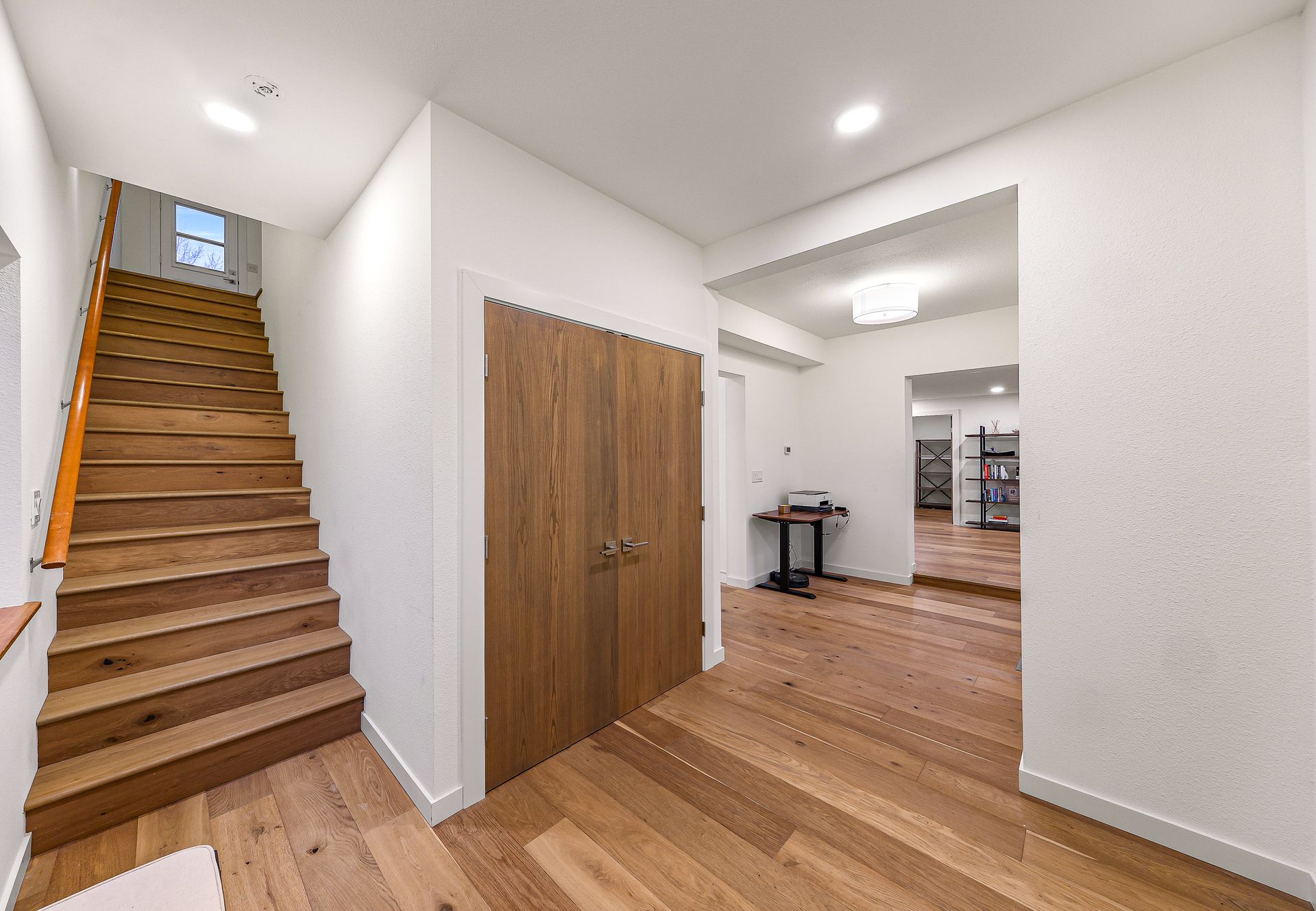 Main hallway with wood floors and recessed lighting.