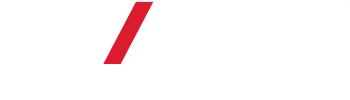 A white REMAX Whatcom County logo with red line