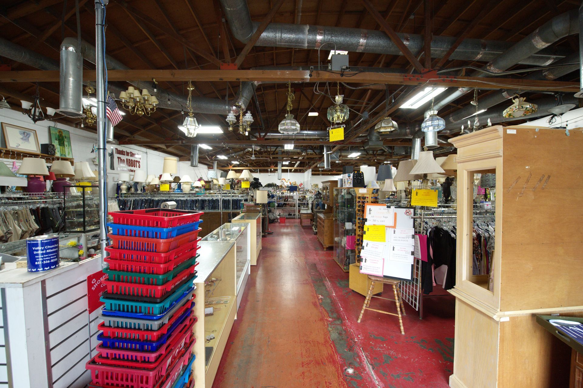 The inside of a thrift store with a lot of crates stacked on top of each other.
