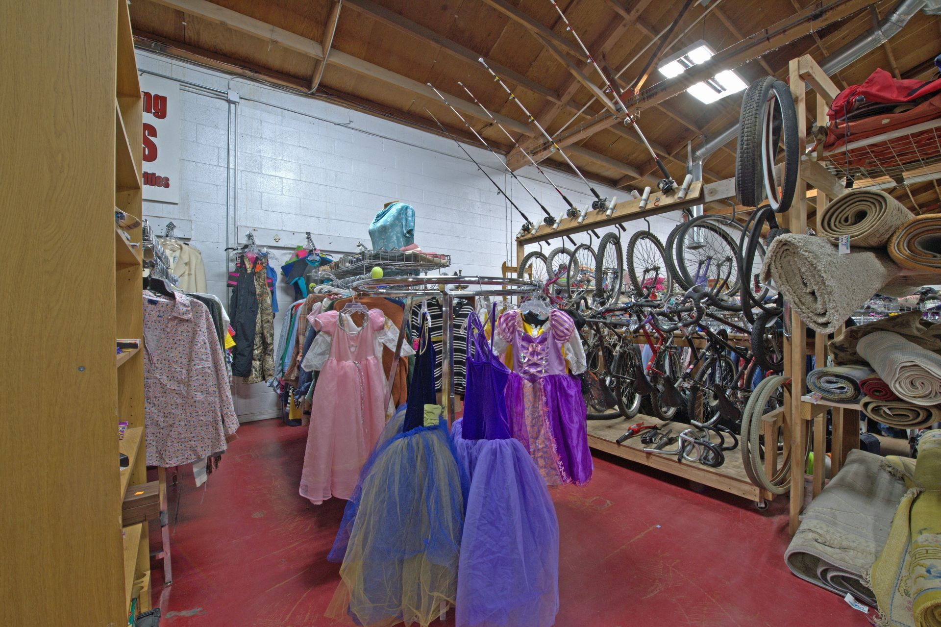 A store filled with lots of dresses and bicycles.