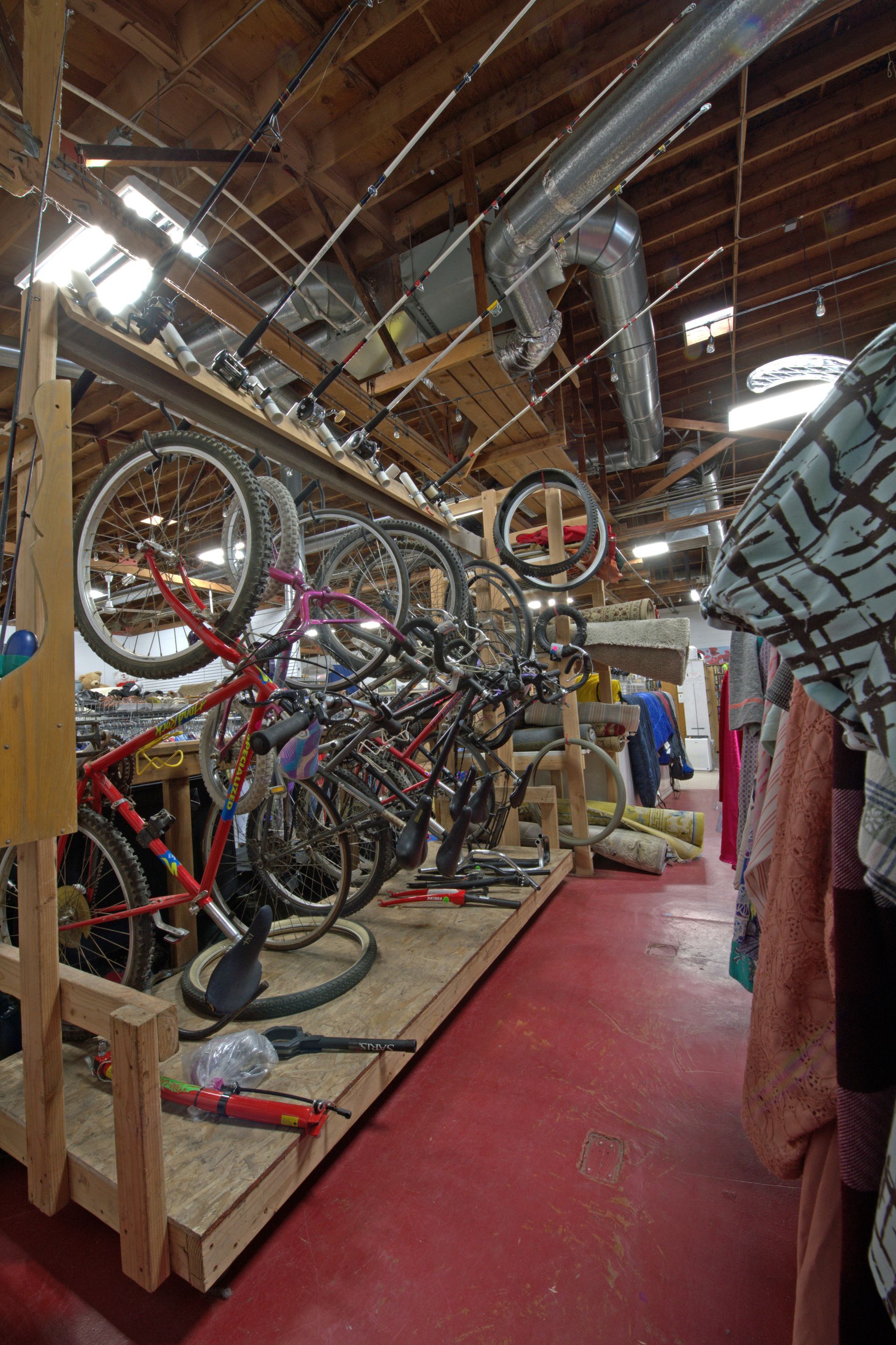 A bunch of bicycles are lined up in a room