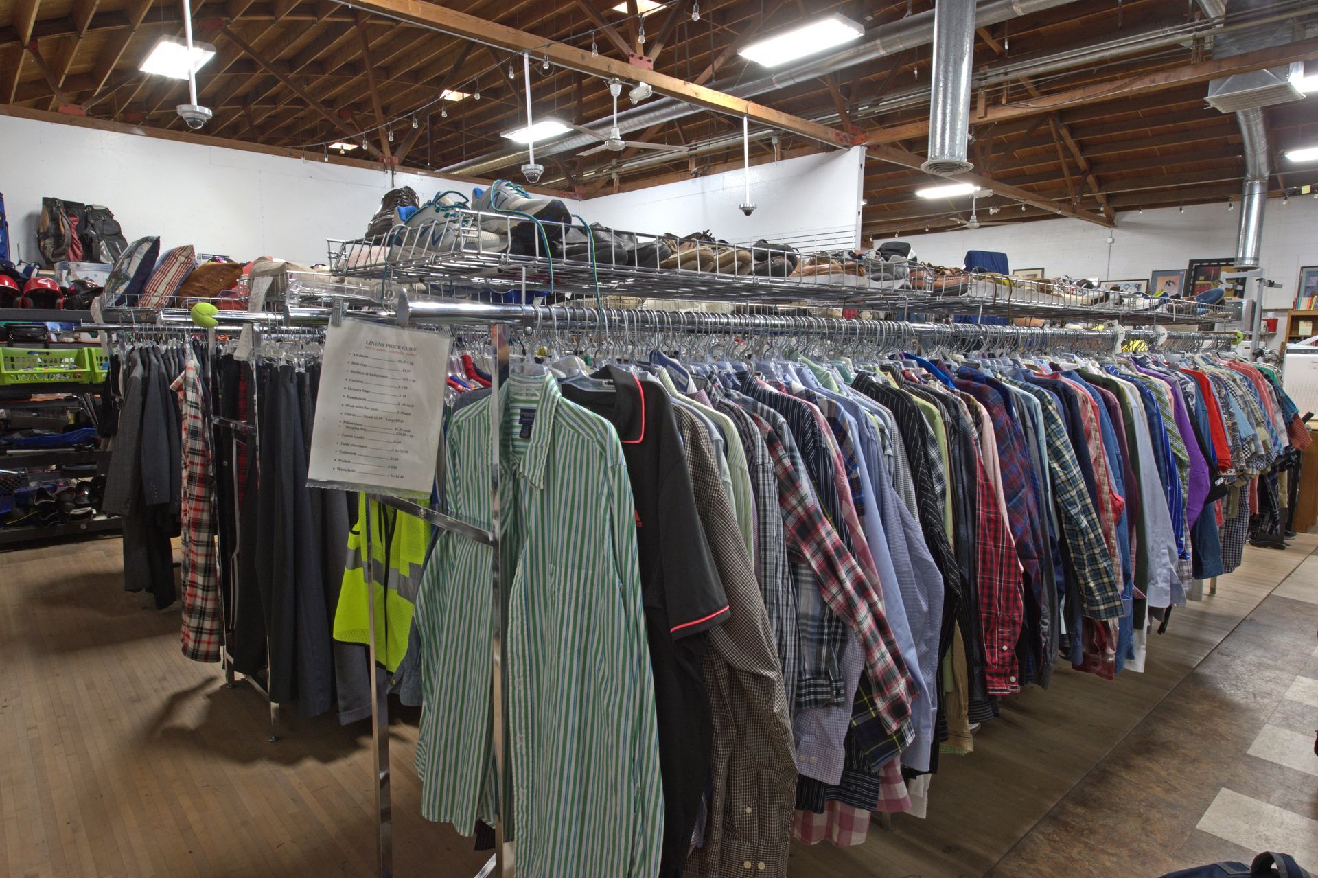 A store filled with lots of clothes hanging on racks.
