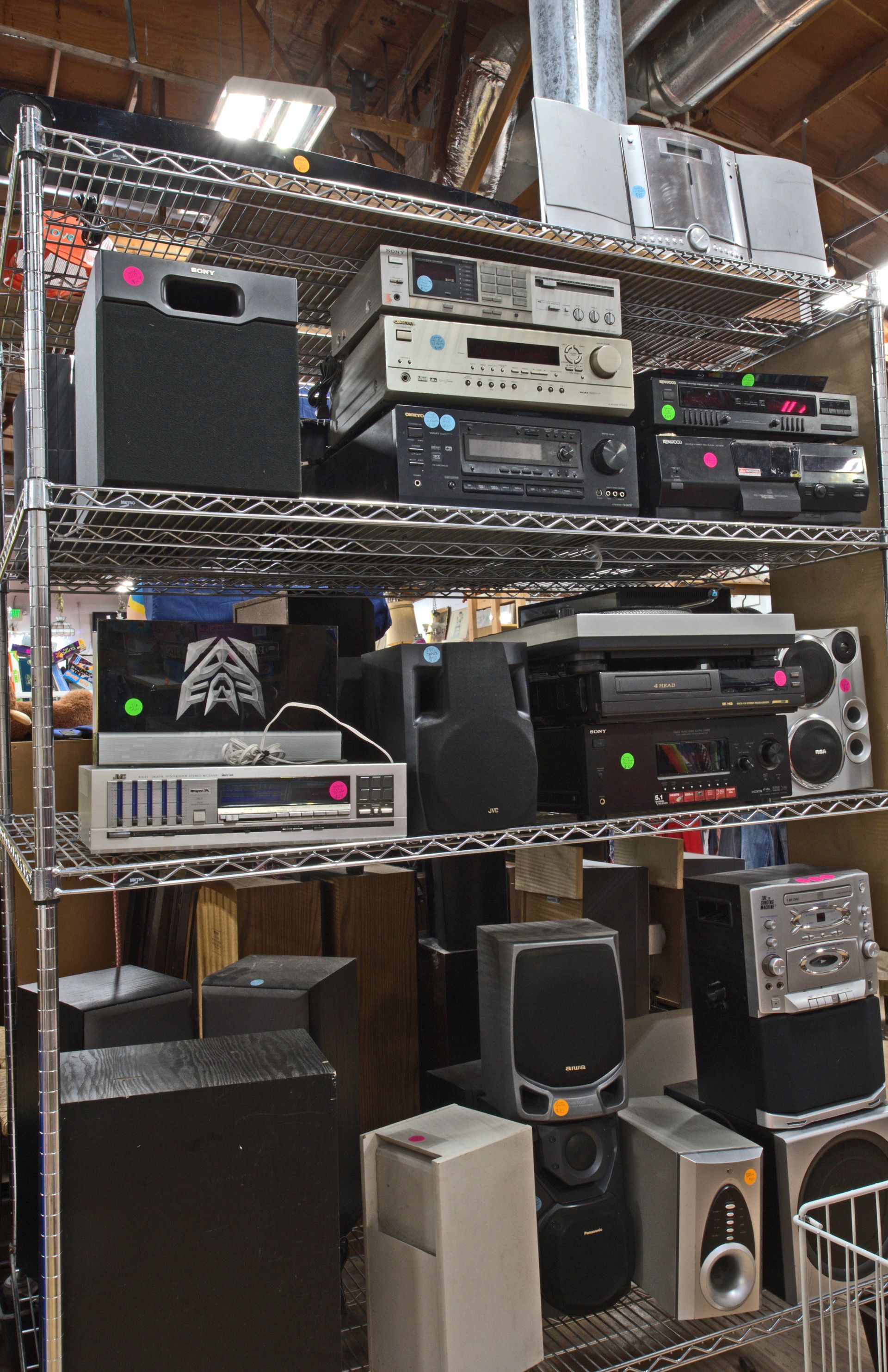 A bunch of speakers are on a rack in a store