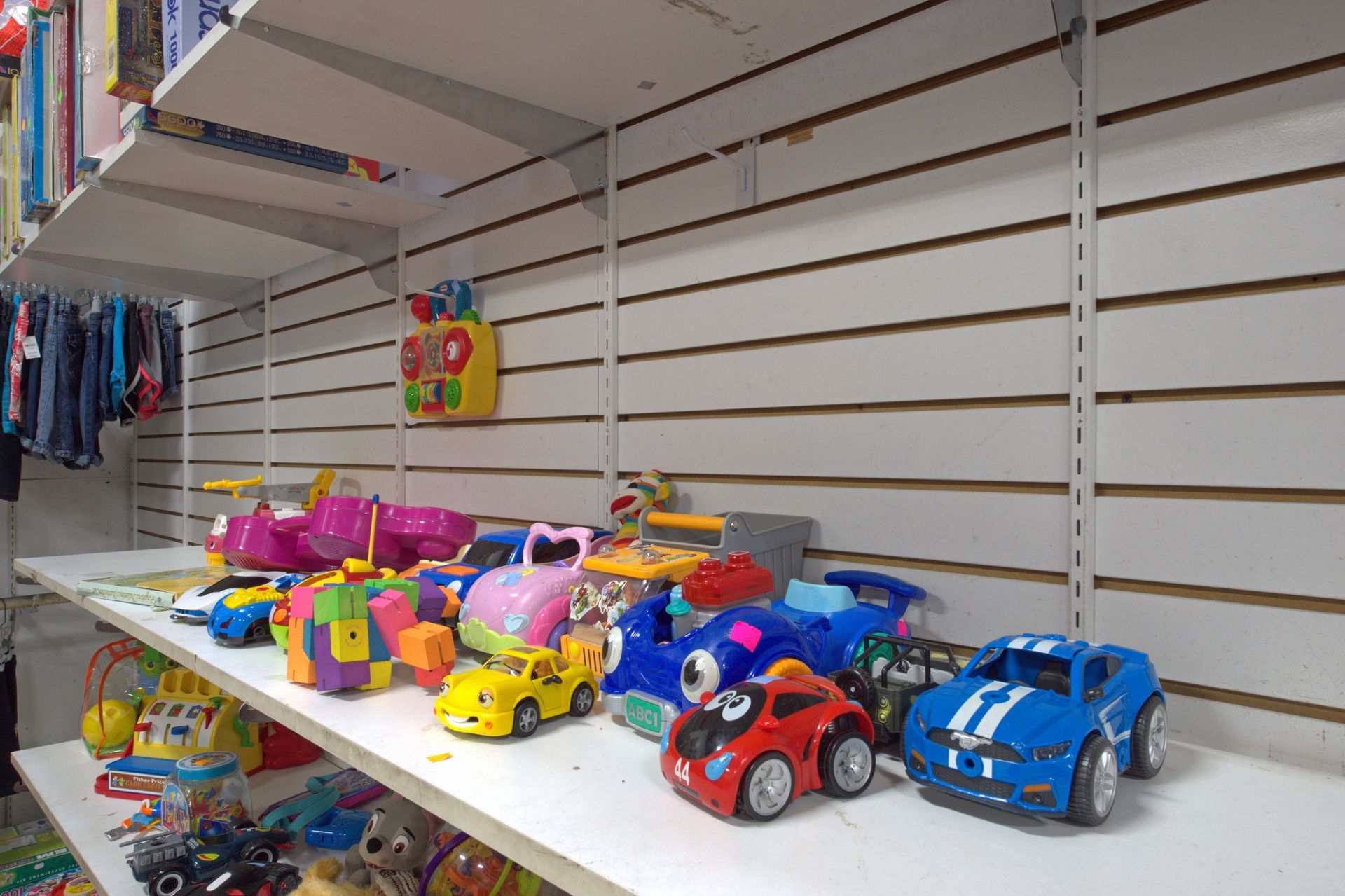 A bunch of toys are sitting on a shelf in a store.