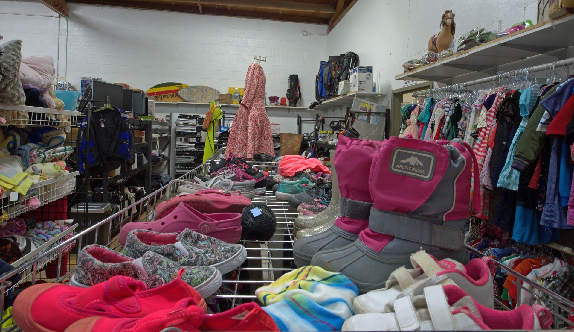 A store filled with lots of shoes and clothes.