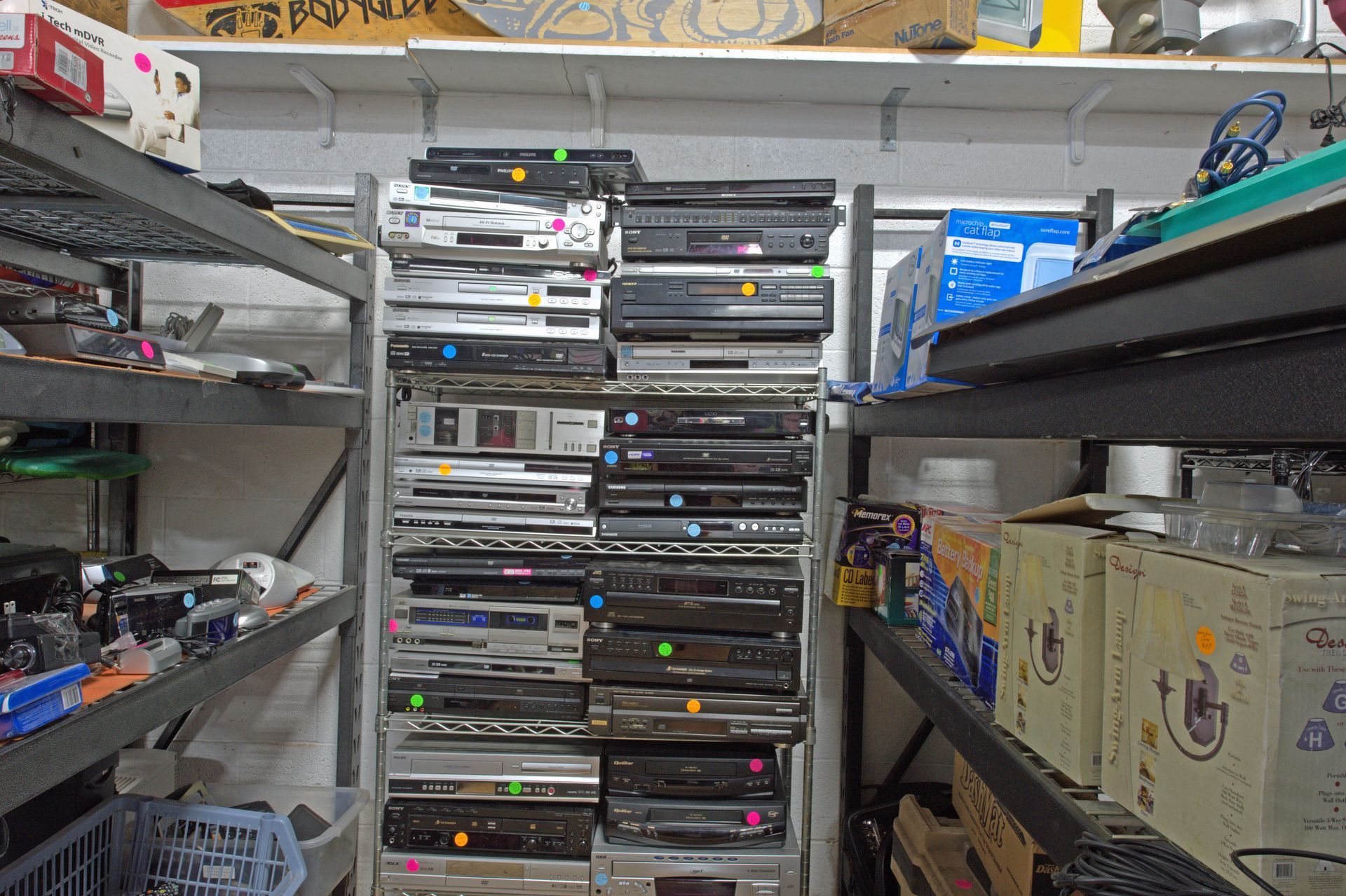 A warehouse filled with lots of dvd players and boxes