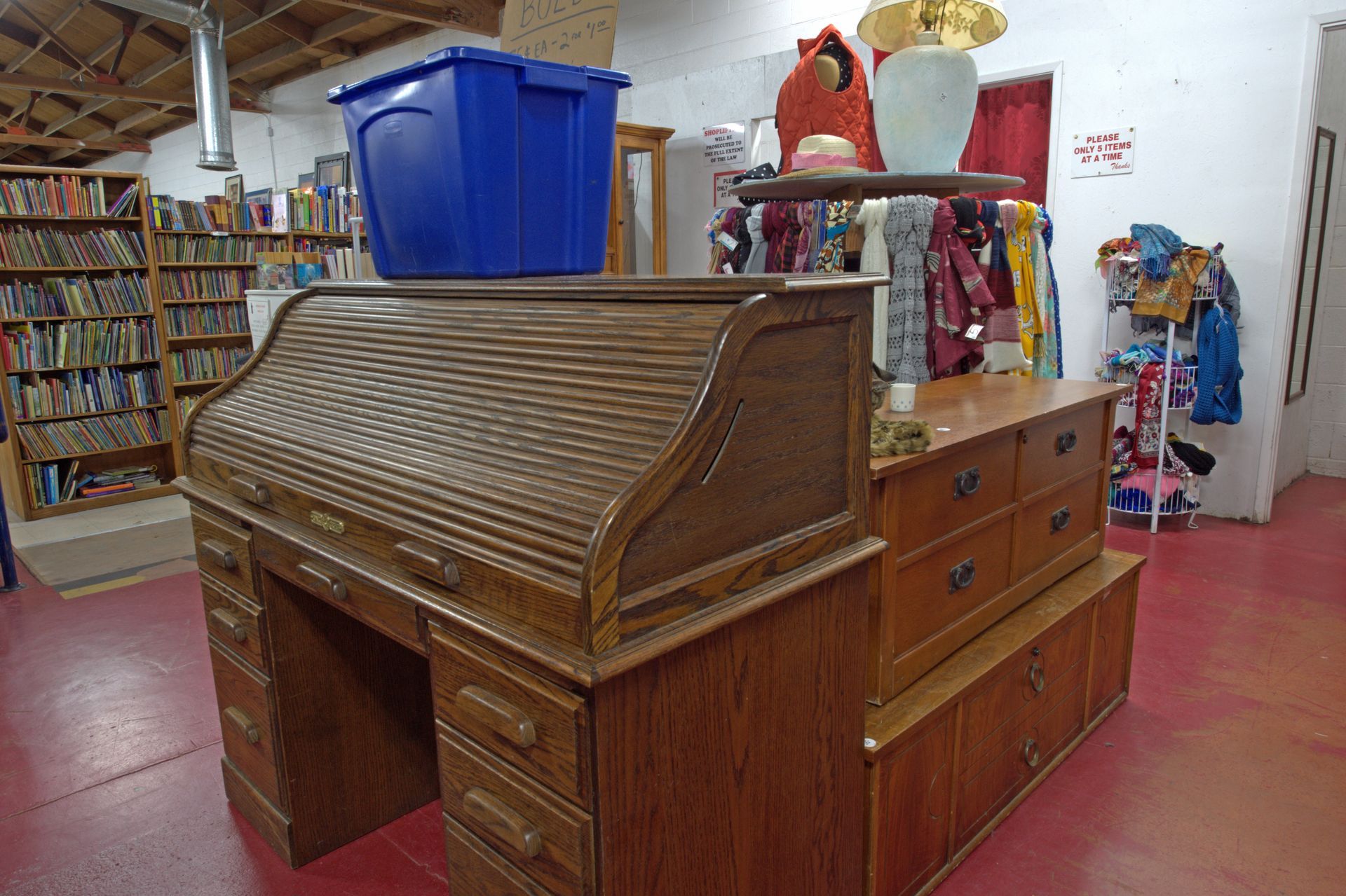 A wooden desk with a blue box on top of it