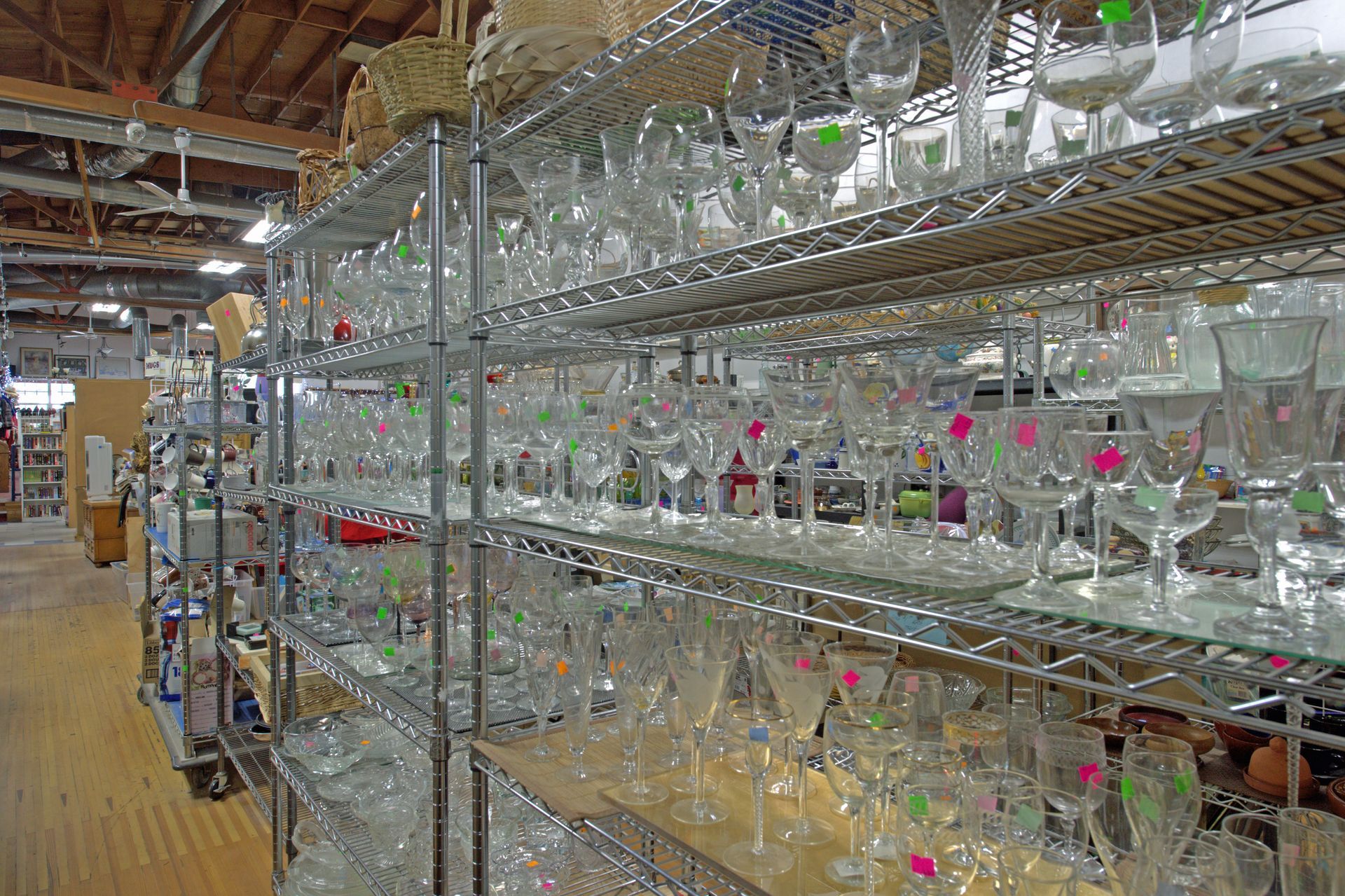 A warehouse filled with lots of wine glasses on shelves.
