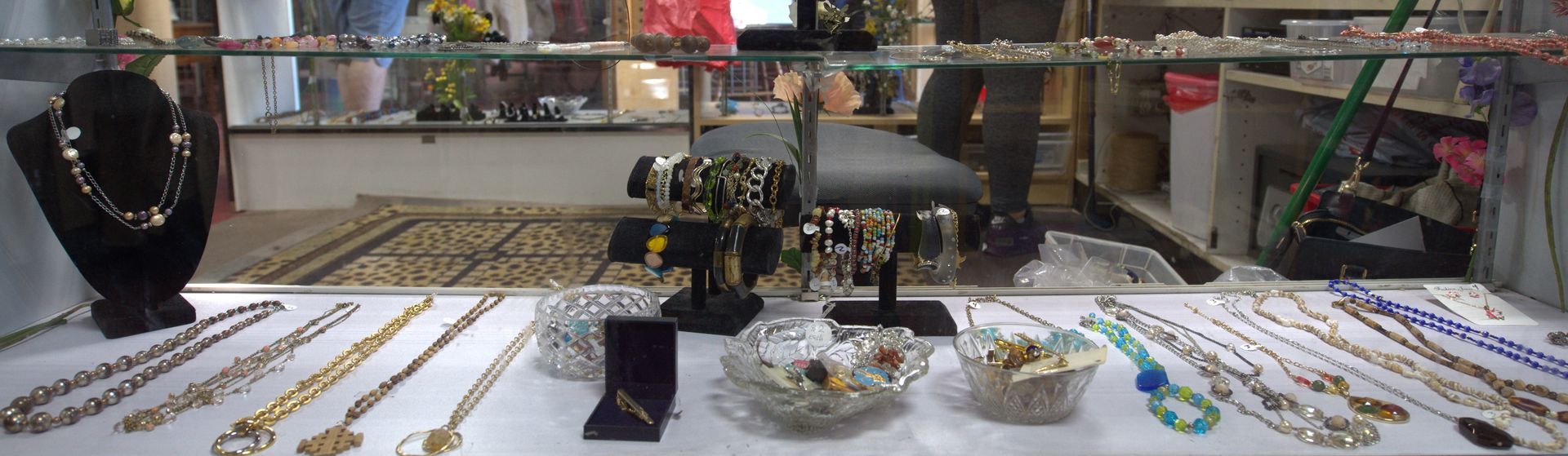 A display case filled with necklaces and bracelets in a store.