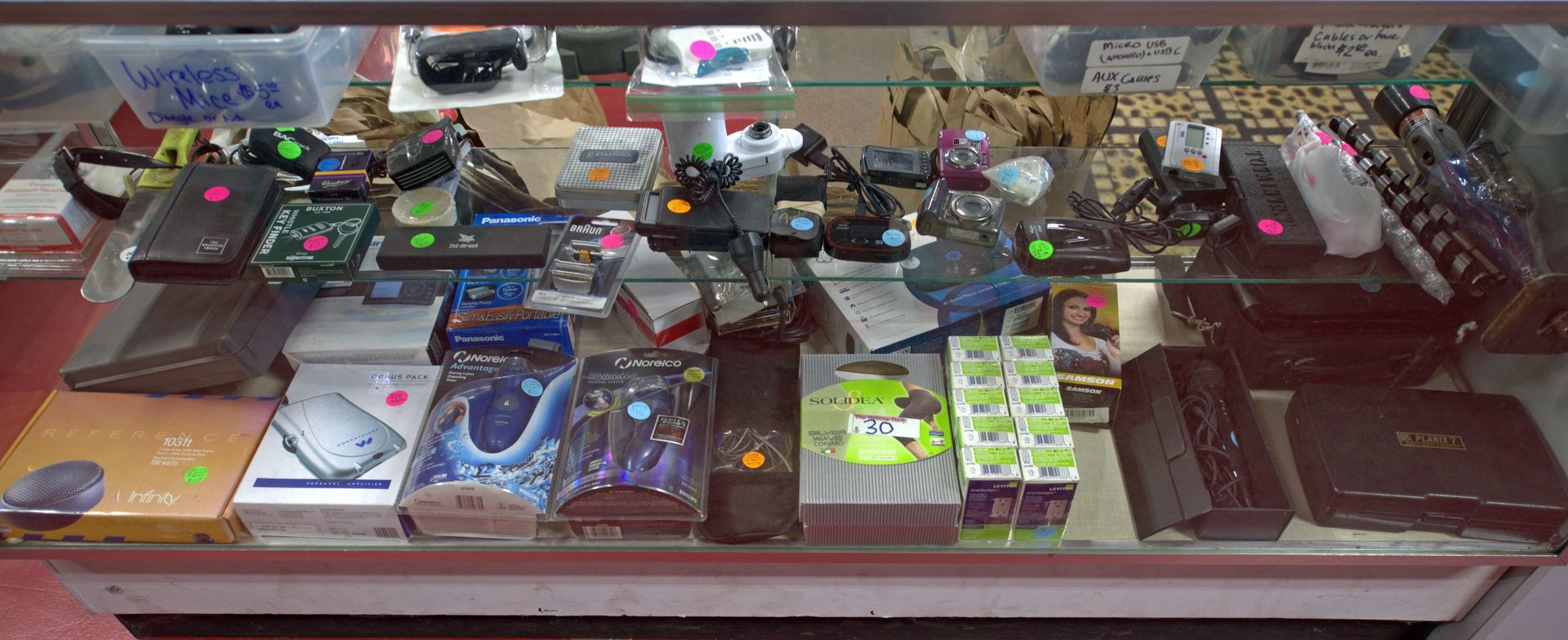 A display case filled with a variety of electronic devices.