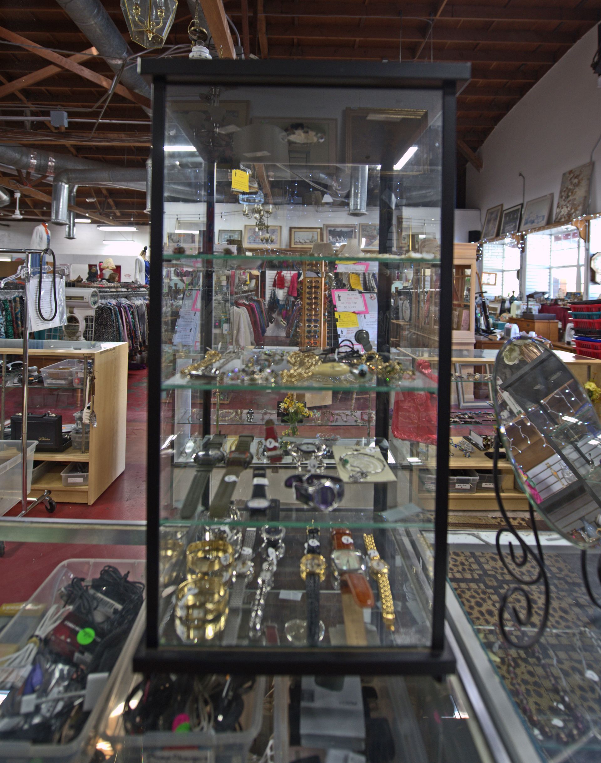 A glass display case filled with lots of items in a store