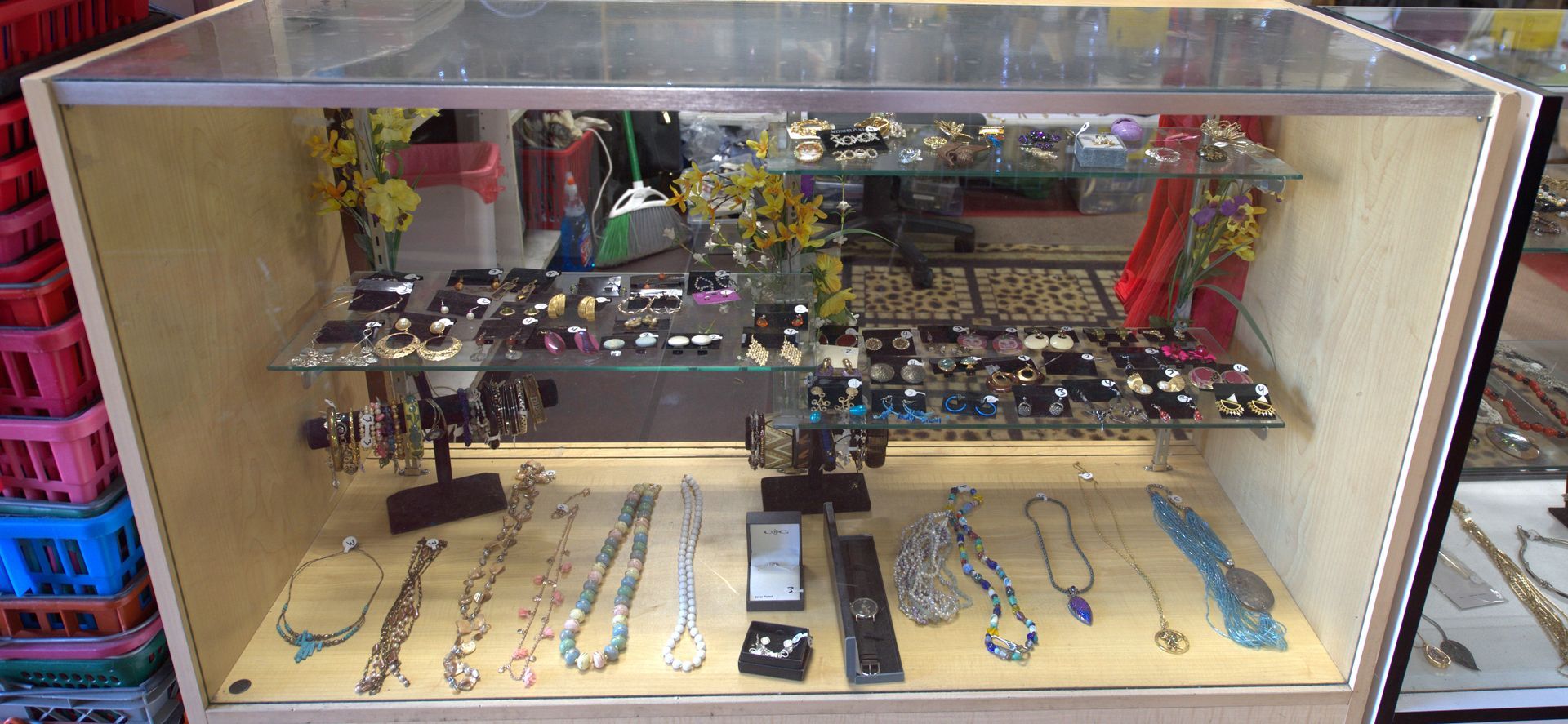 A display case filled with lots of jewelry in a store.