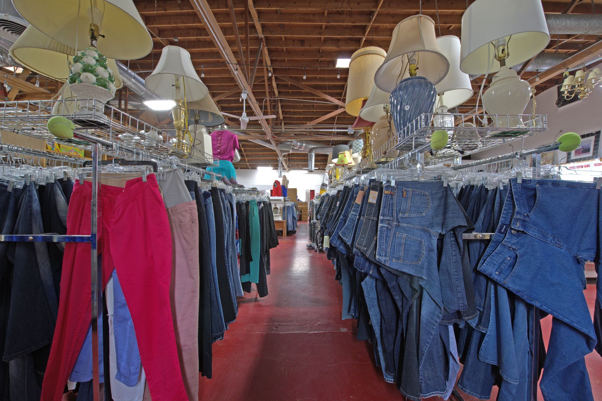 A store filled with lots of clothes and lamps