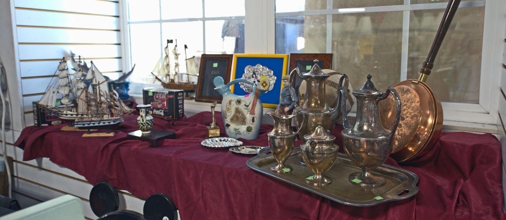 A table with a lot of antique items on it.