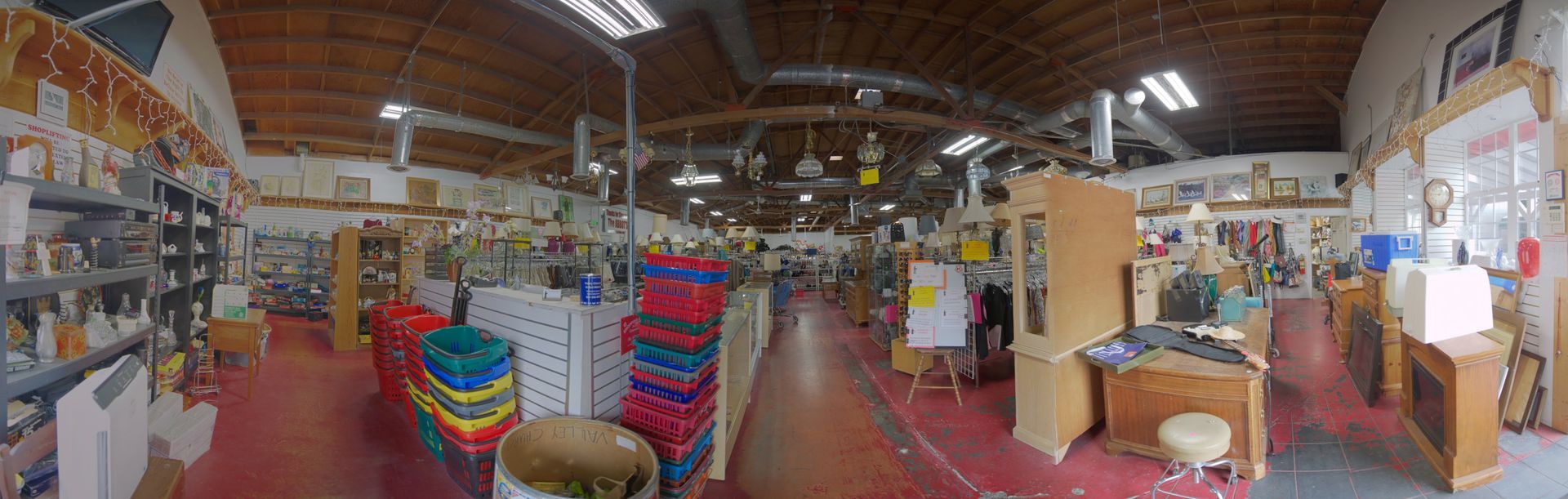 A large warehouse filled with lots of furniture and containers.