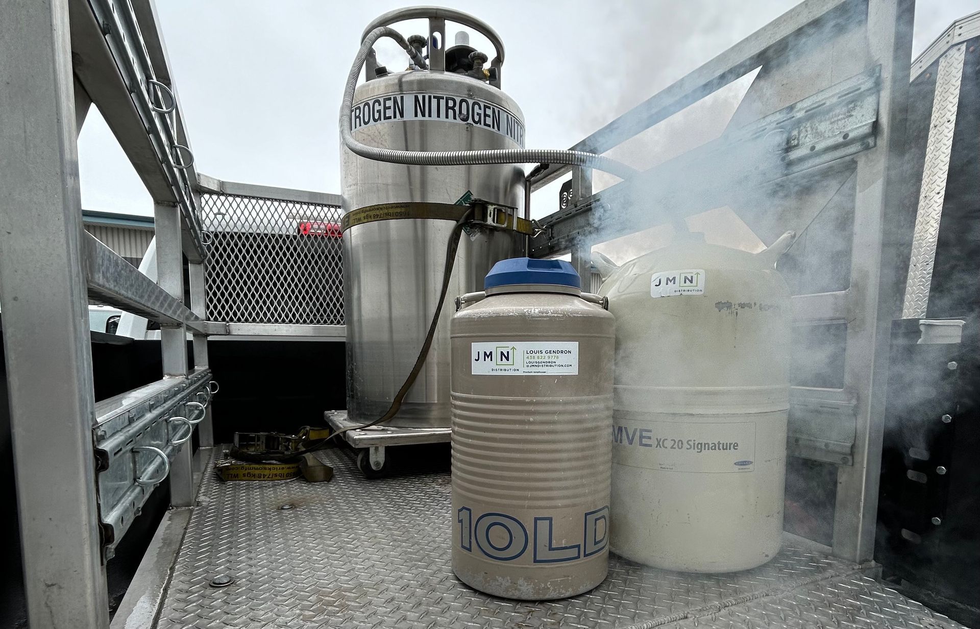 Liquid nitrogen tanks on a truck, emitting vapor.