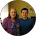 A man and a woman are standing next to each other in a circle.