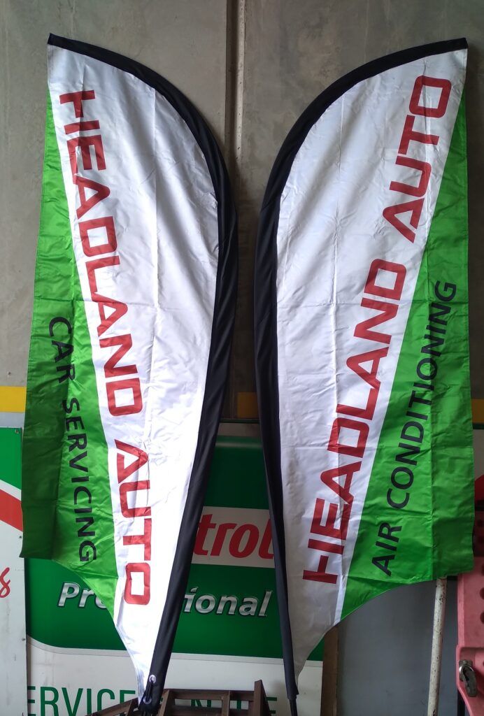 Two Flags For Headland Auto Are Hanging On A Wall — Headland Auto Servicing & Air Conditioning In Alexandra Headland, QLD