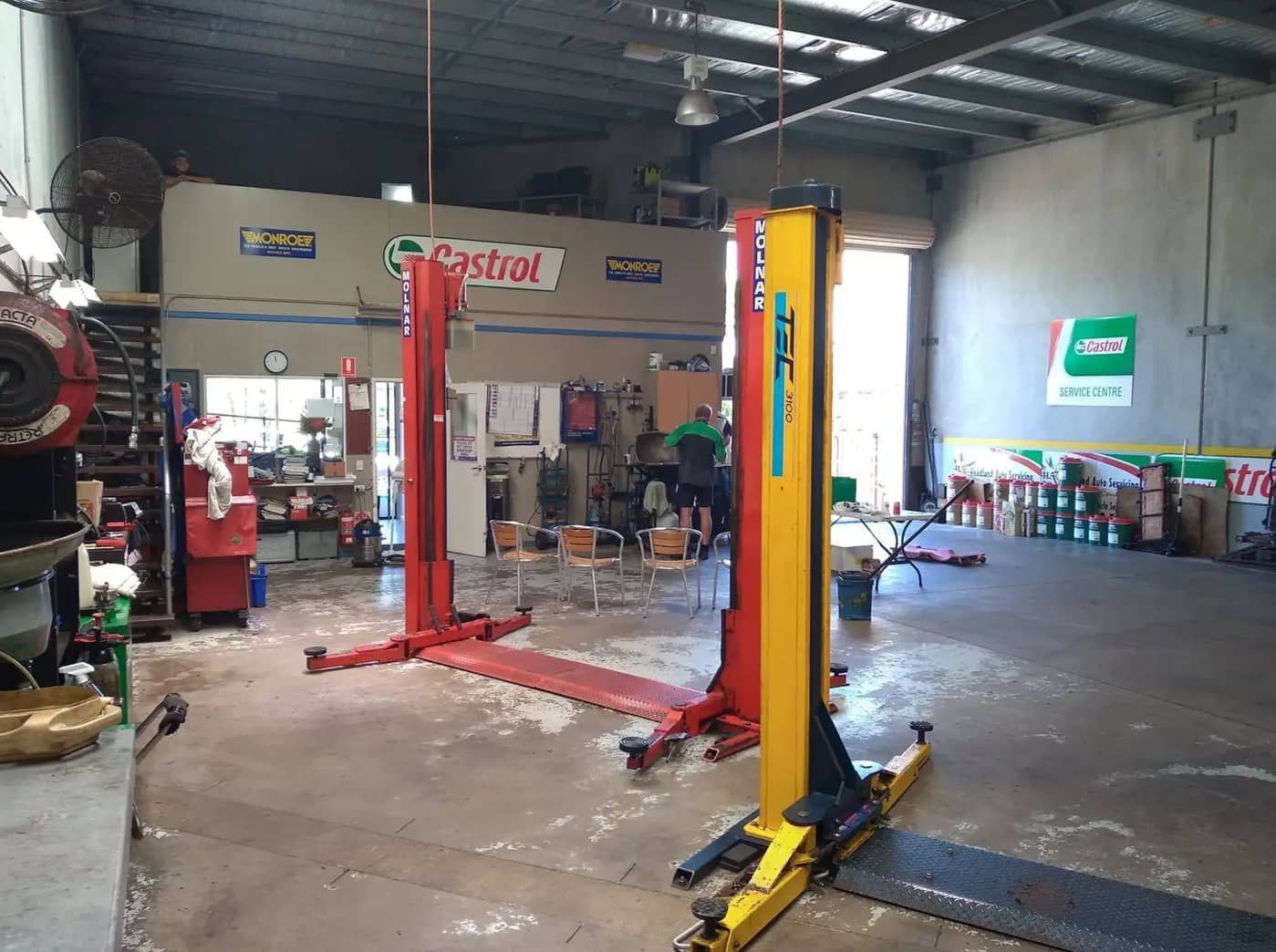 A Garage With Two Lifts In It — Headland Auto Servicing & Air Conditioning In Alexandra Headland, QLD