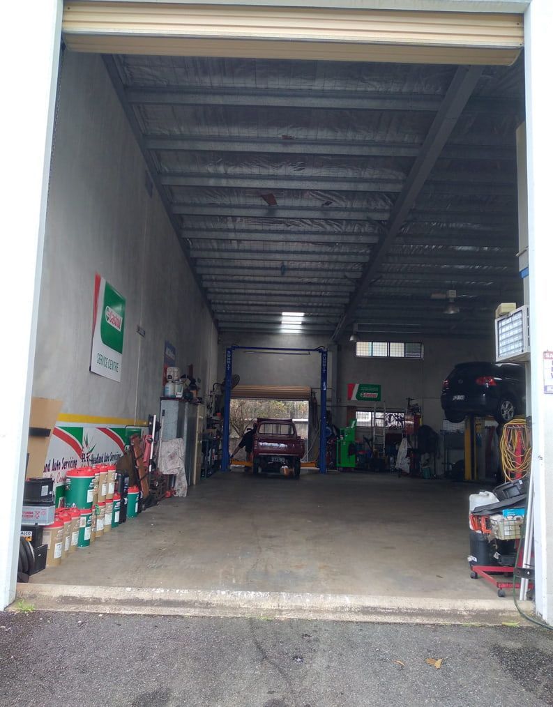A Car Is Parked In A Garage With The Door Open — Headland Auto Servicing & Air Conditioning In Alexandra Headland, QLD