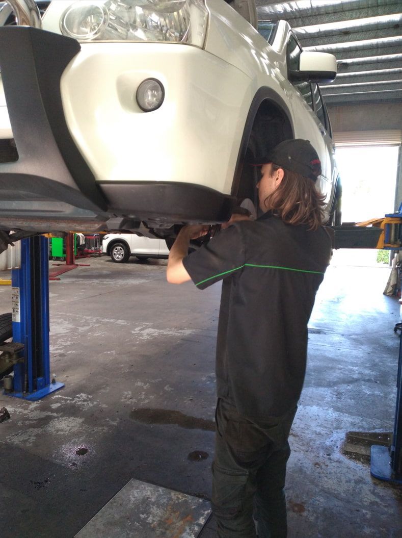 A Man Is Working On A Car In A Garage — Headland Auto Servicing & Air Conditioning In Alexandra Headland, QLD