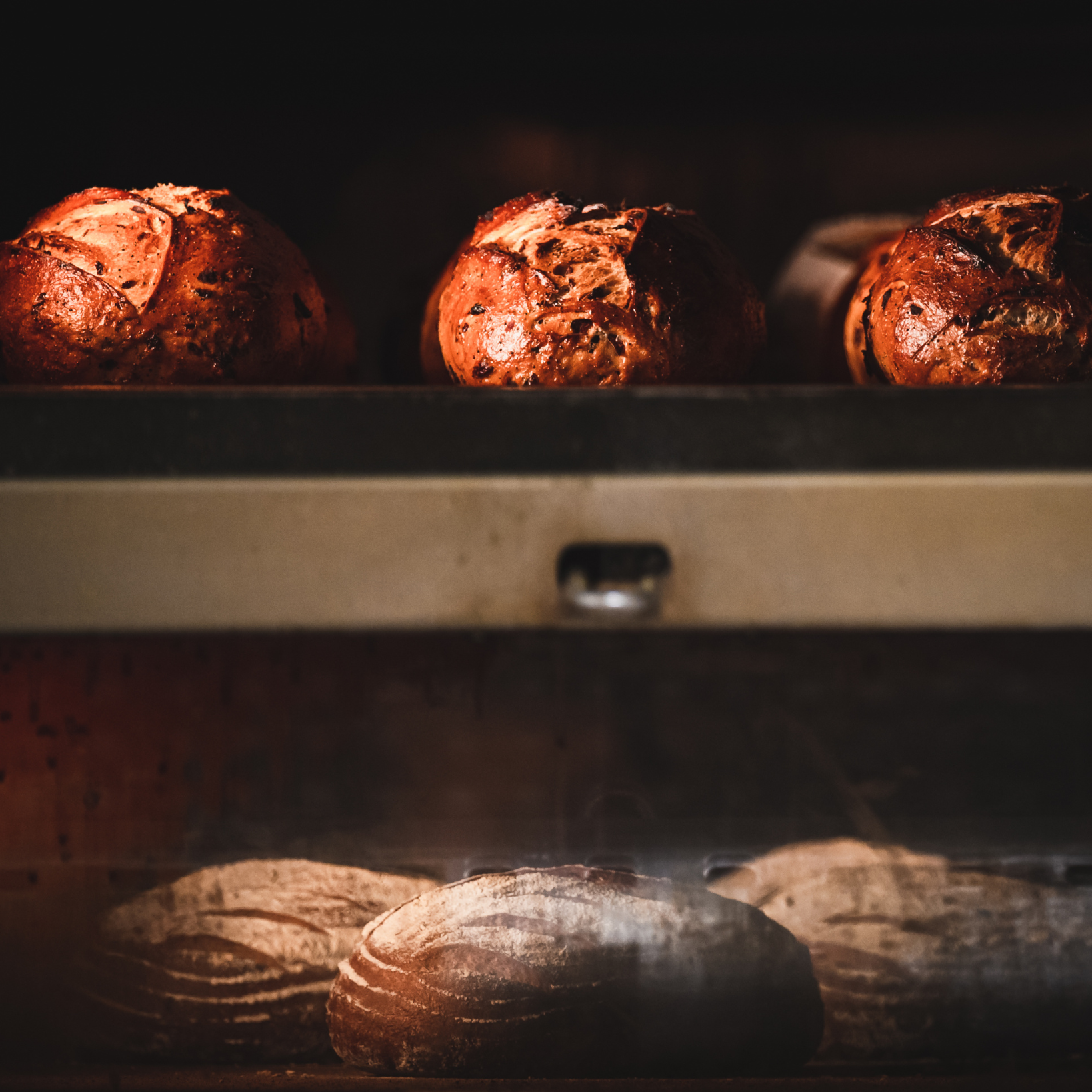 A bunch of bread is being baked in an oven.