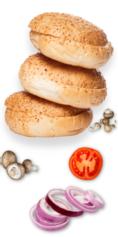 A stack of burger buns with onions, tomatoes, and mushrooms.