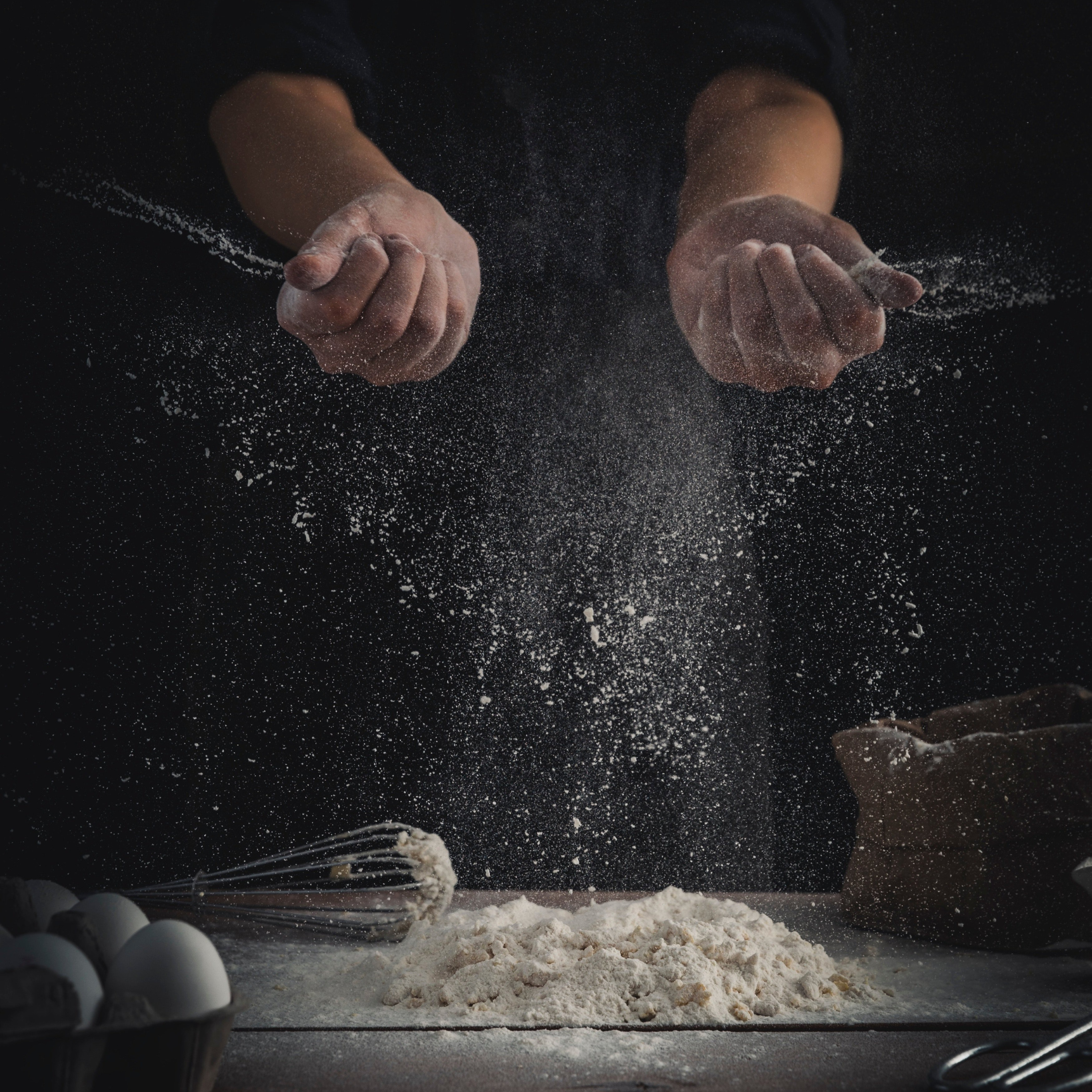 A person is throwing flour into the air.