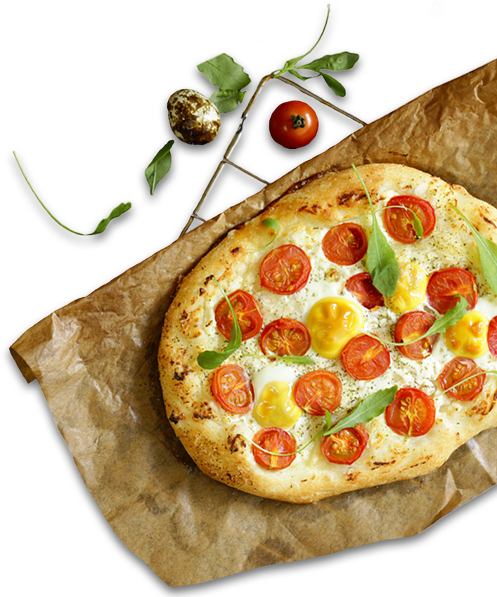 Pizza with perfect crust, cherry tomatoes, fresh basil, and mozzarella on parchment paper