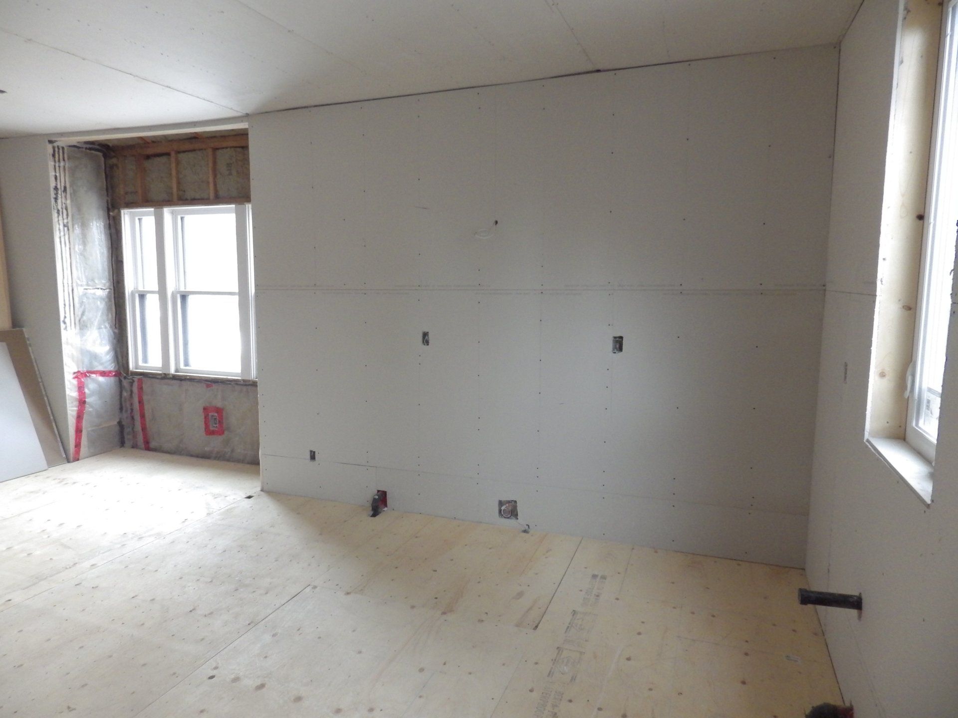 renovation looking at unfinished drywall in kitchen.