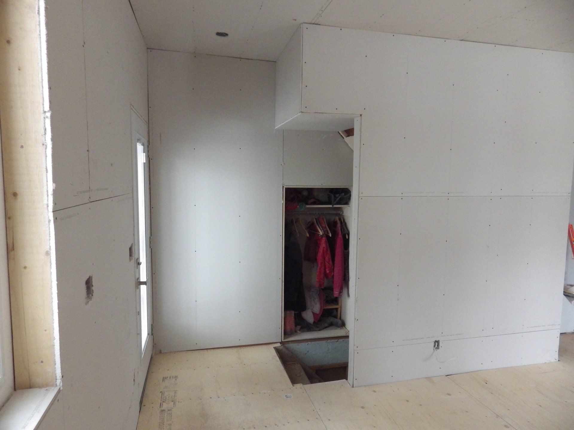 renovation,back door, closet, stairs leadin to basement.